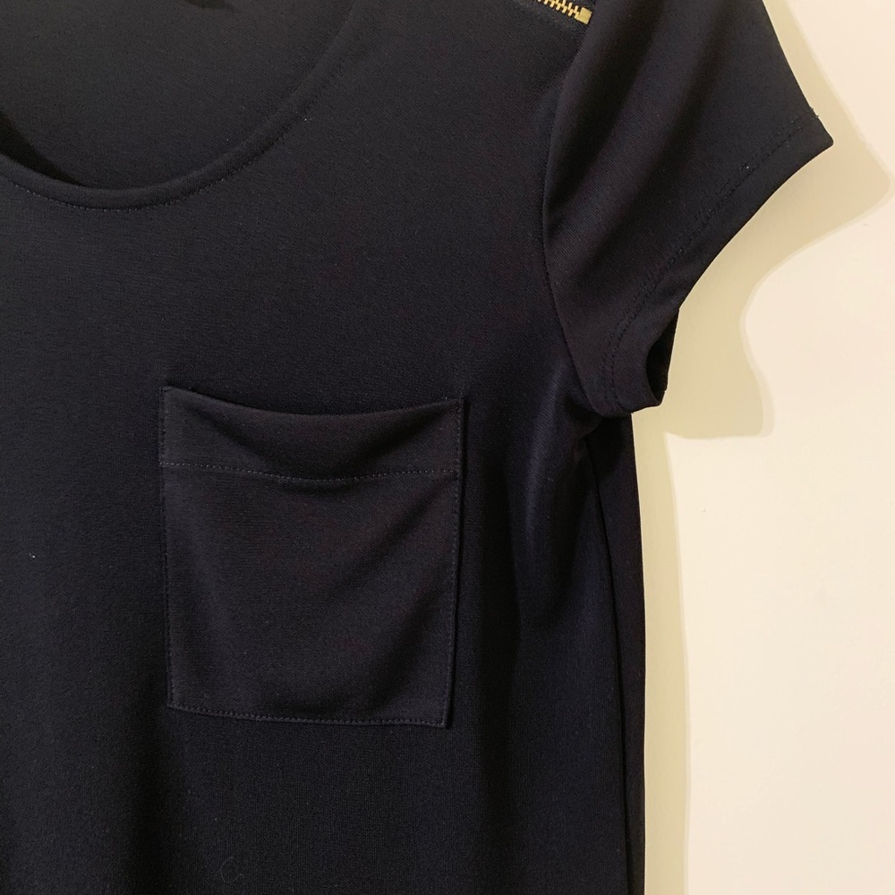 One pocket black top with gold zipper hardware.